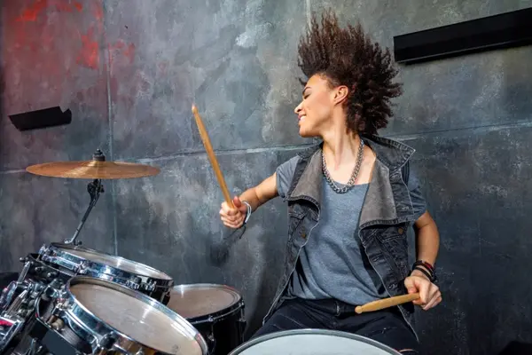 Why did the drummer keep banging her head against the drums?